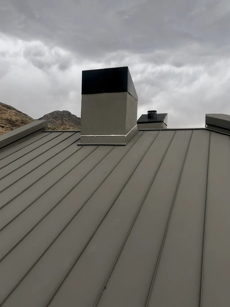 Standing seam metal roof on a home with desert mountain views